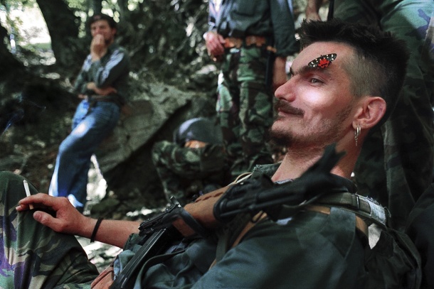A butterfly lands on the face of resting Bosnian Serb. (Photo by Kamenko Pajic)